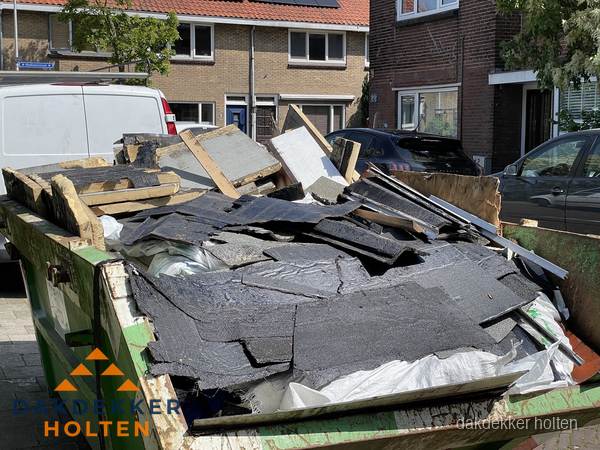 Afvalcontainer met gesloopt dakmateriaal tijdens dakkapel renovatie in Holten Afvalcontainer met gesloopt dakmateriaal tijdens dakkapel renovatie in Holten